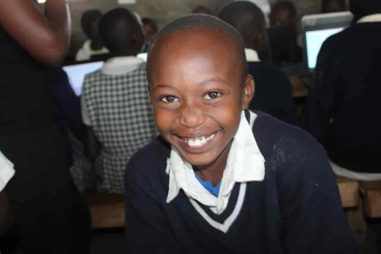 Excited kids learning digital skills in TechLit computer classes