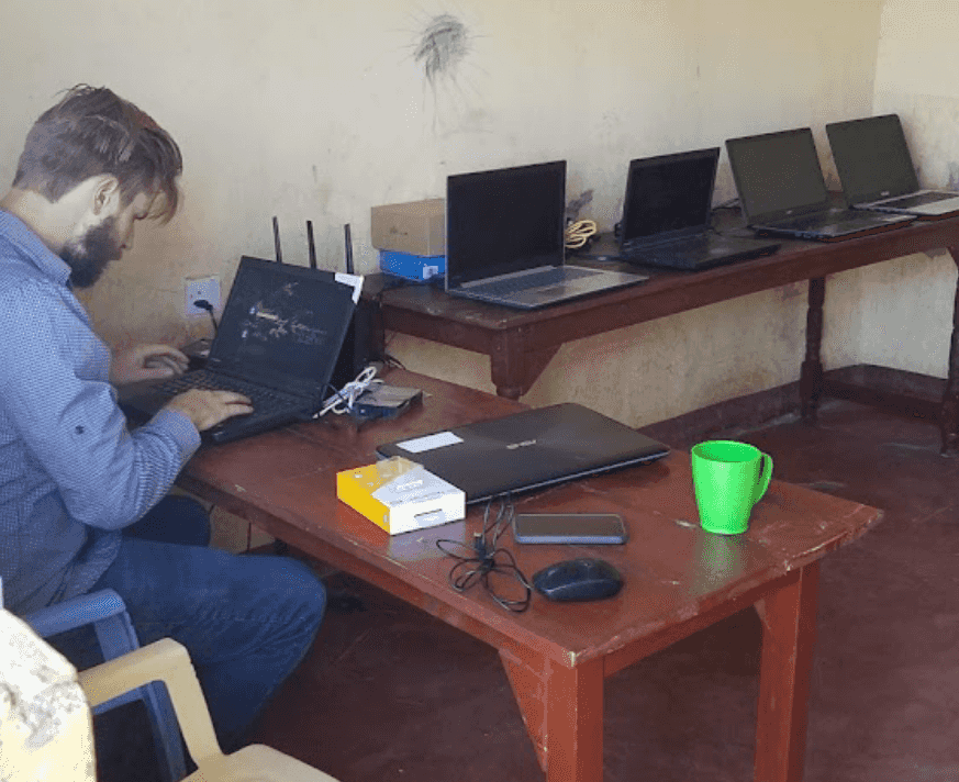 TechLit founder Tyler configuring a school classroom