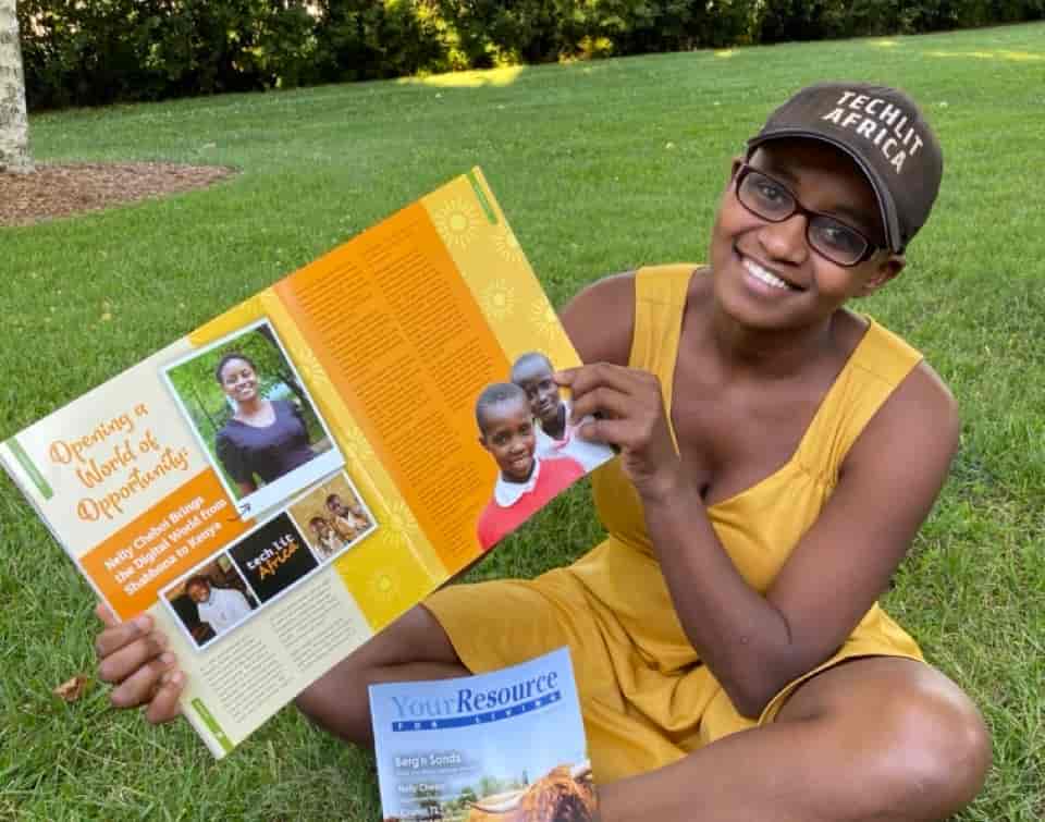 Nelly Cheboi holding an article from Resource Bank